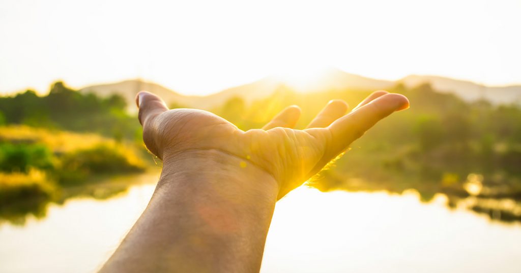 Hand Reaching Out to the Sun